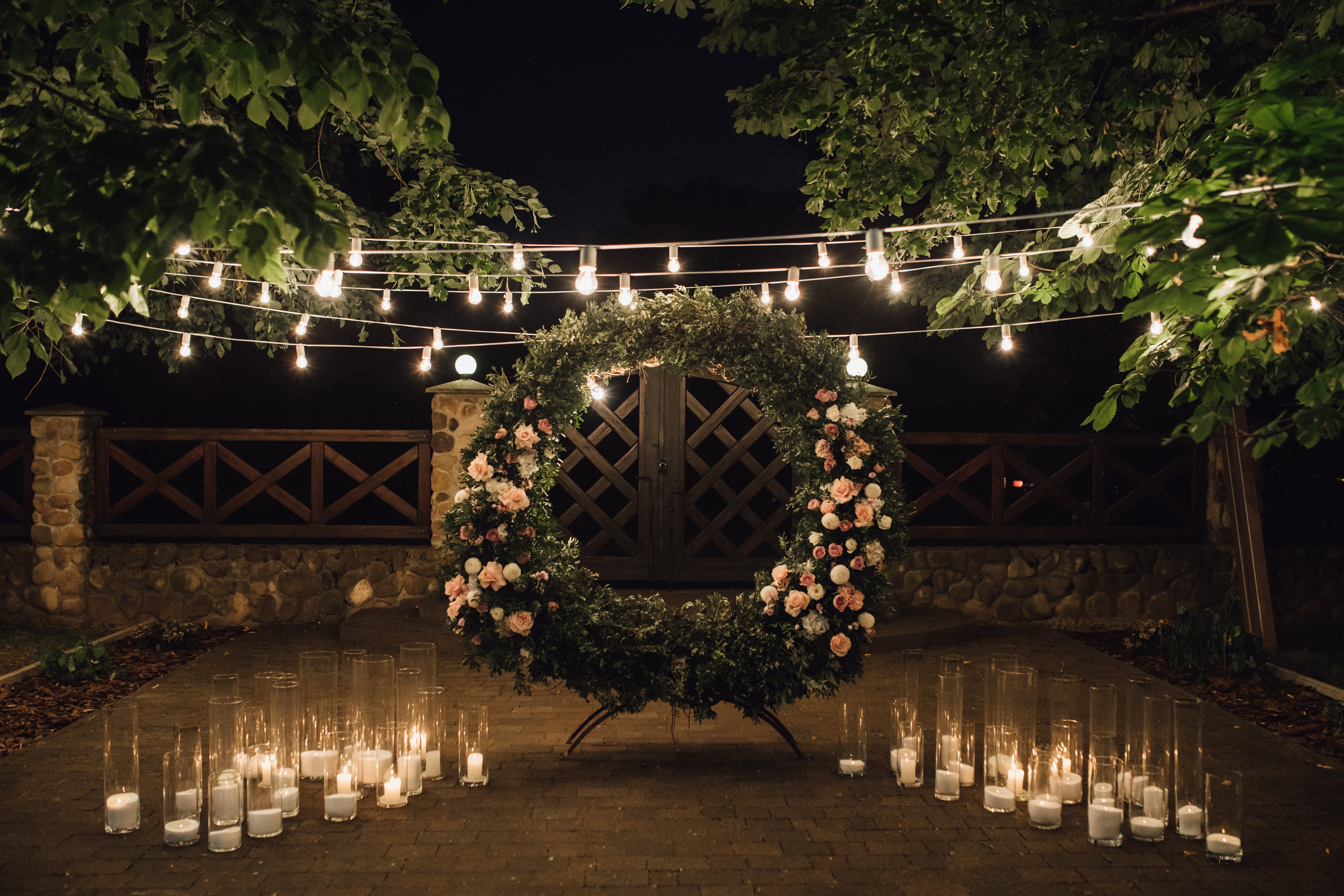 Statement wedding lighting with candles and chandeliers.